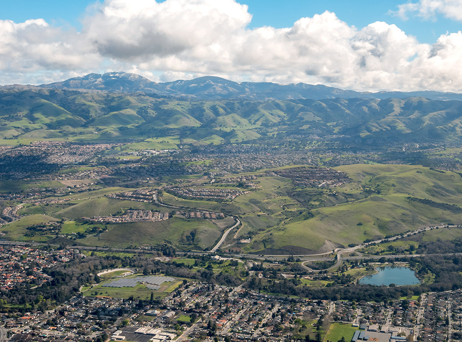 Aerial view of Walnut Creek, California. Mountains are in the background.